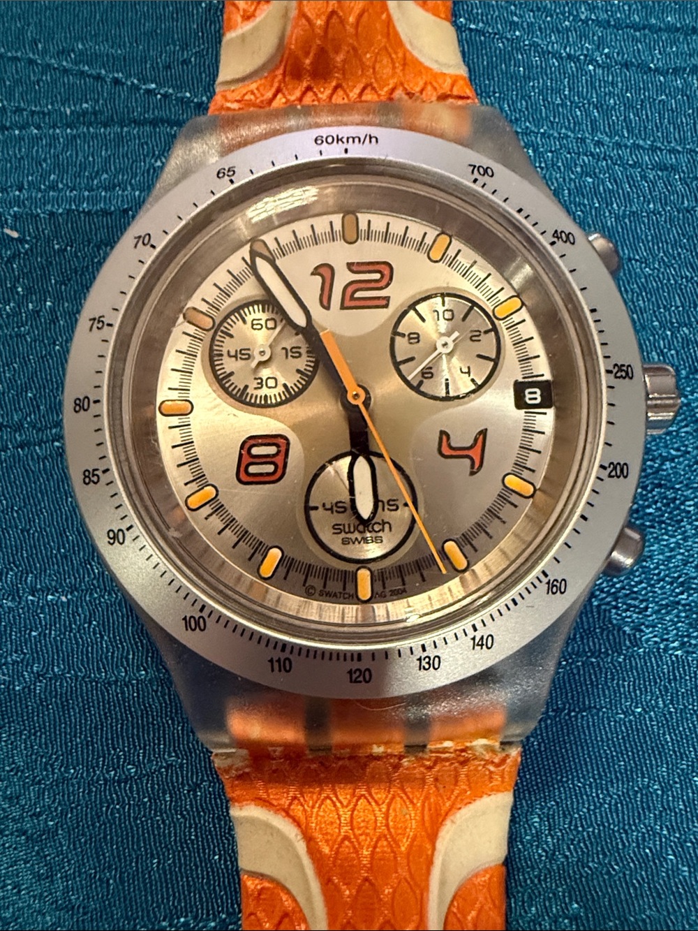 Swatch Silver Dial Watch with Orange Strap Accents